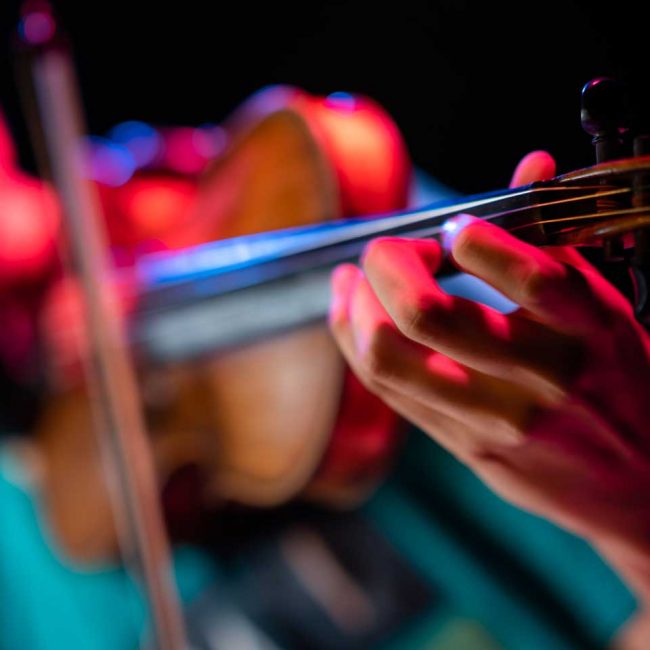 Closeup of a boy playing the violin